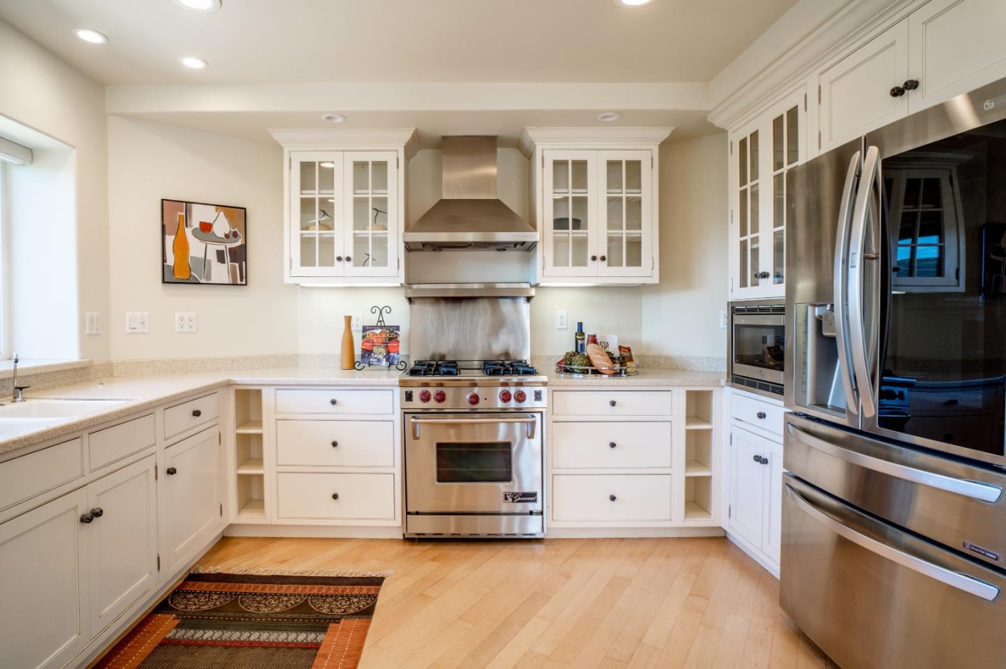 335 El Caminito Road Carmel Valley, CA 93924 - Photo 14 of 59 a kitchen with stainless steel appliances white cabinets and a stove