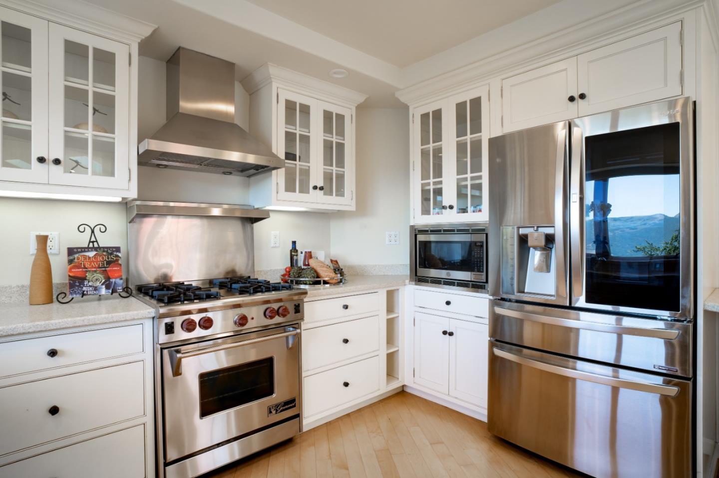 335 El Caminito Road Carmel Valley, CA 93924 - Photo 15 of 59 a kitchen with stainless steel appliances a stove and a refrigerator