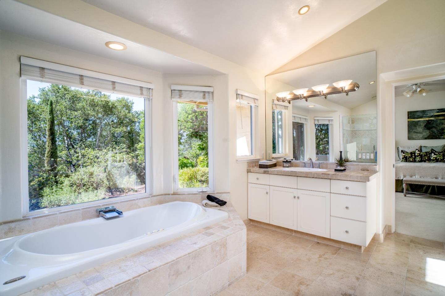 335 El Caminito Road Carmel Valley, CA 93924 - Photo 31 of 59 a bathroom with a granite countertop tub a double vanity sink a large mirror a window and a shower