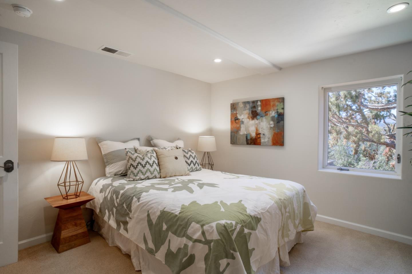 335 El Caminito Road Carmel Valley, CA 93924 - Photo 37 of 59 a bedroom with a bed and a painting on the wall