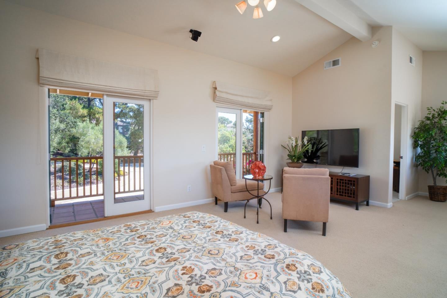 335 El Caminito Road Carmel Valley, CA 93924 - Photo 41 of 59 a living room with furniture a flat screen tv and a large window
