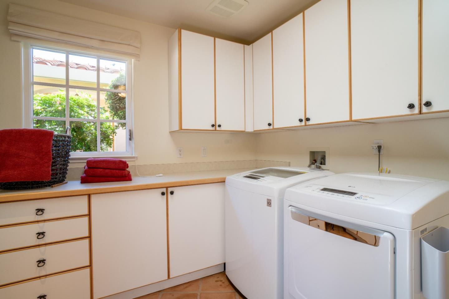 335 El Caminito Road Carmel Valley, CA 93924 - Photo 42 of 59 a utility room with stainless steel appliances white cabinets and a window