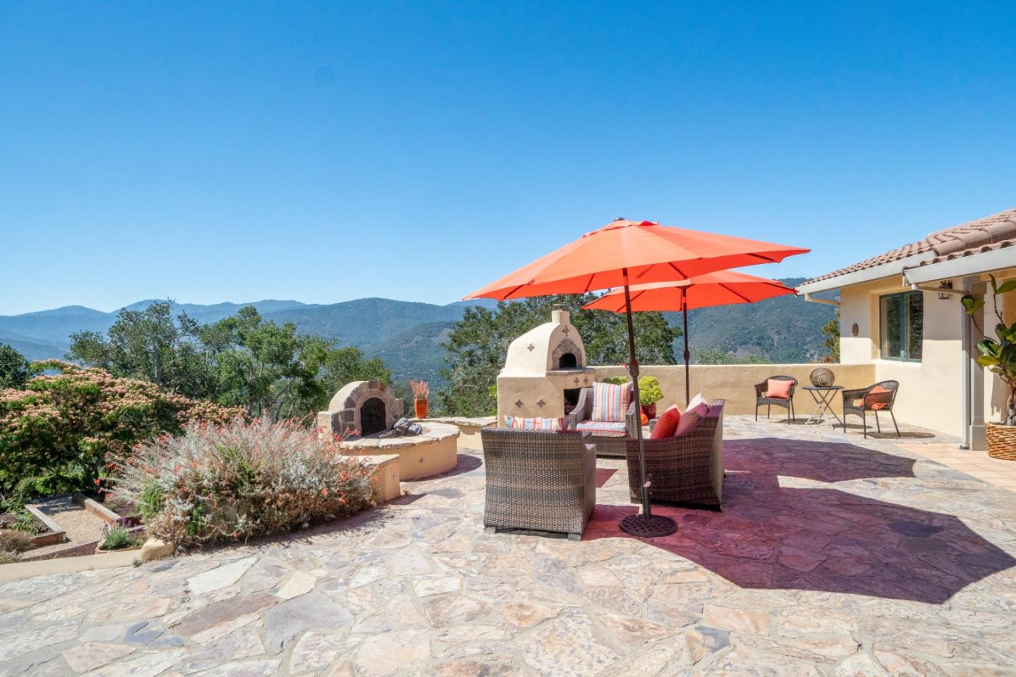 335 El Caminito Road Carmel Valley, CA 93924 - Photo 45 of 59 a view of a patio with a table and chairs under an umbrella
