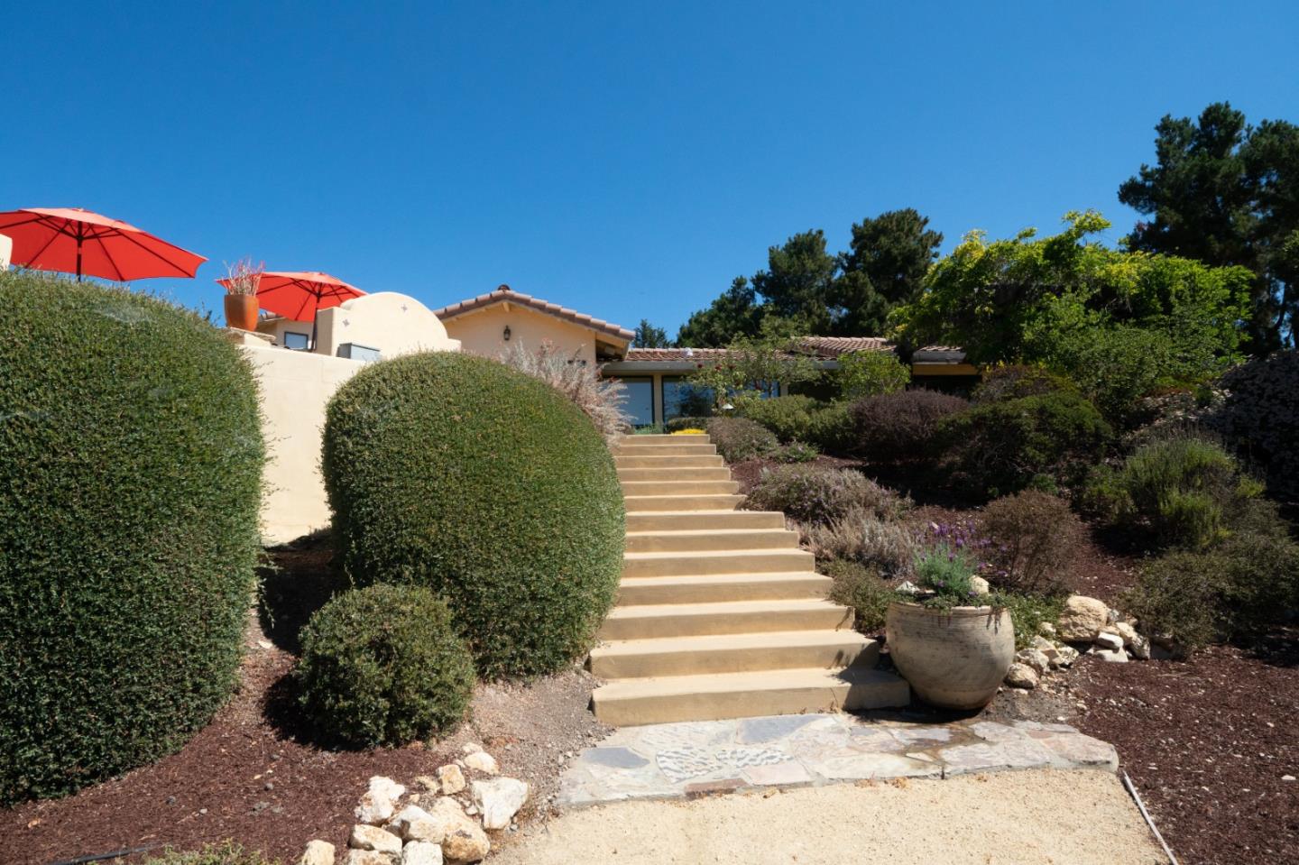 335 El Caminito Road Carmel Valley, CA 93924 - Photo 46 of 59 a view of a garden with a building in the background