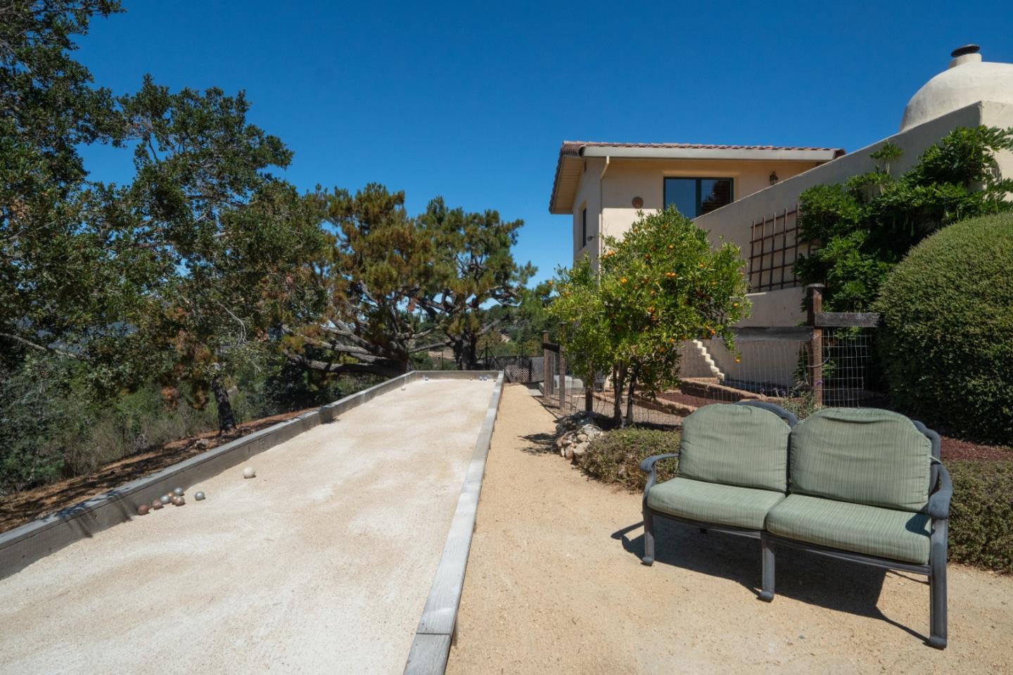 335 El Caminito Road Carmel Valley, CA 93924 - Photo 49 of 59 a view of a patio with couches and a potted plant on a table