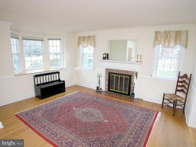 213 Blenheim Road Baltimore, MD 21212 - Photo 2 of 16 a living room with furniture and a fireplace