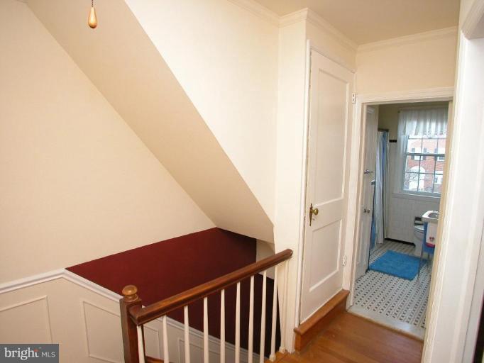 213 Blenheim Road Baltimore, MD 21212 - Photo 11 of 16 a view of a hallway with wooden floor and staircase