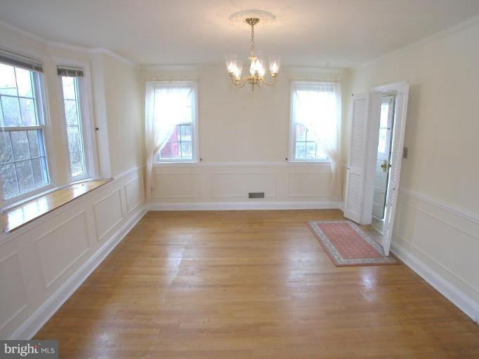 213 Blenheim Road Baltimore, MD 21212 - Photo 4 of 16 wooden floor in an empty room with a window