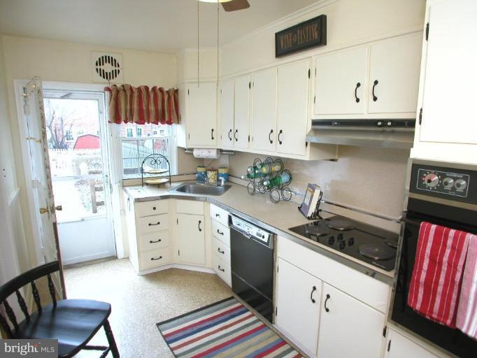 213 Blenheim Road Baltimore, MD 21212 - Photo 6 of 16 a kitchen with stainless steel appliances a stove a sink and a refrigerator