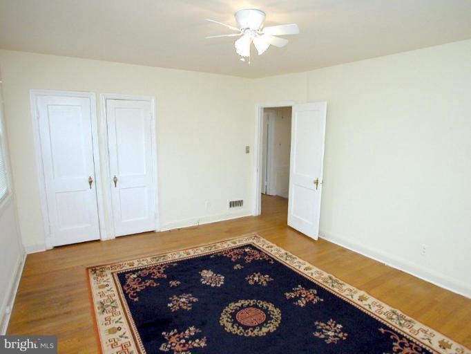 213 Blenheim Road Baltimore, MD 21212 - Photo 7 of 16 a view of an empty room with window and wooden floor