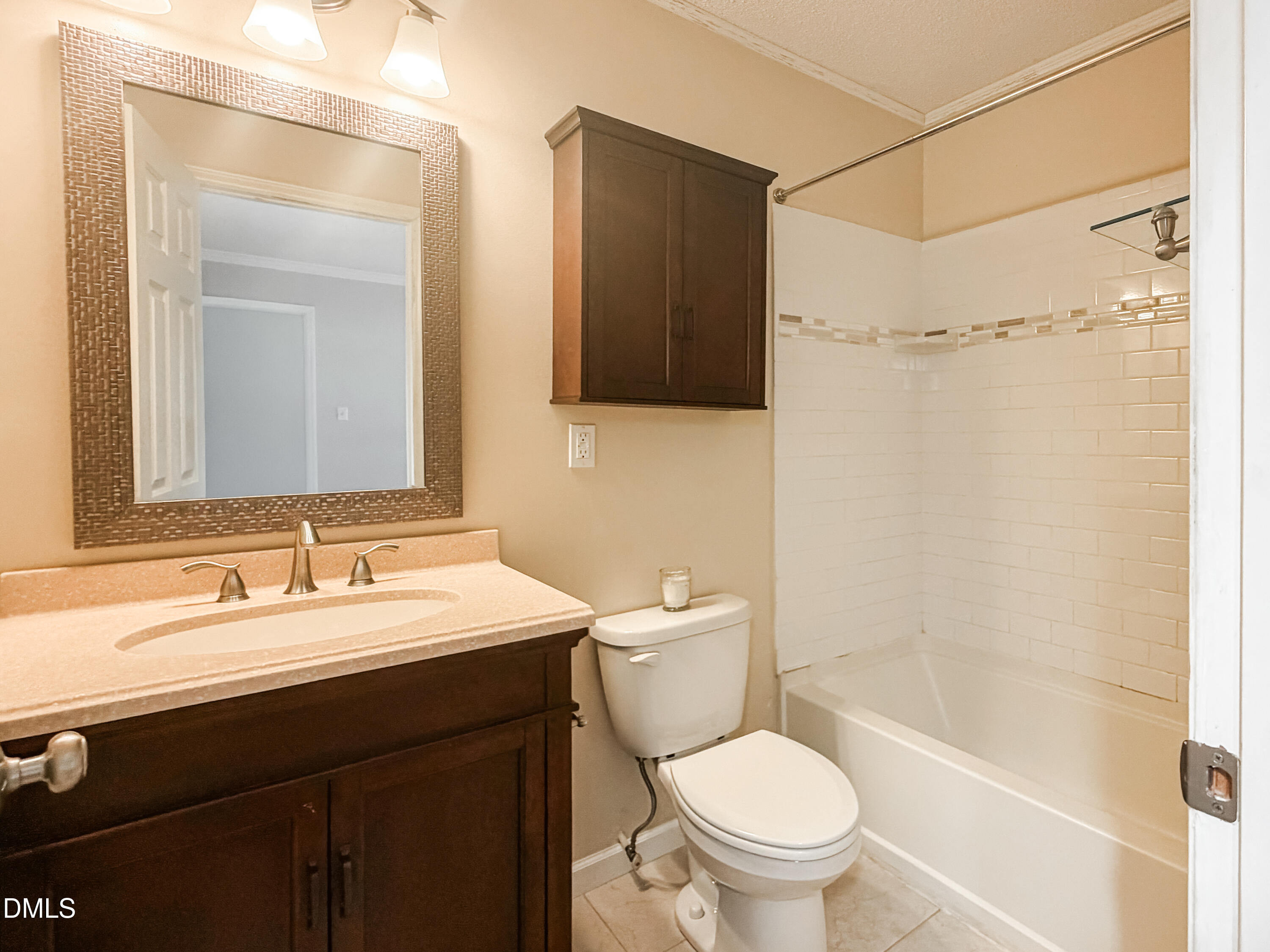 6304 Forest Ridge Drive Durham, NC 27713 - Photo 20 of 29 a bathroom with a sink a toilet a mirror and shower