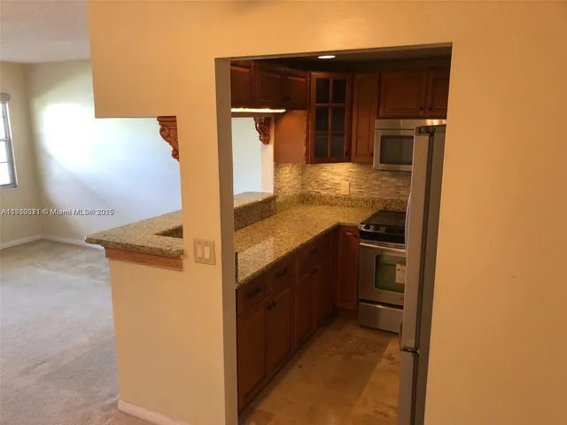 a kitchen with a refrigerator and cabinets