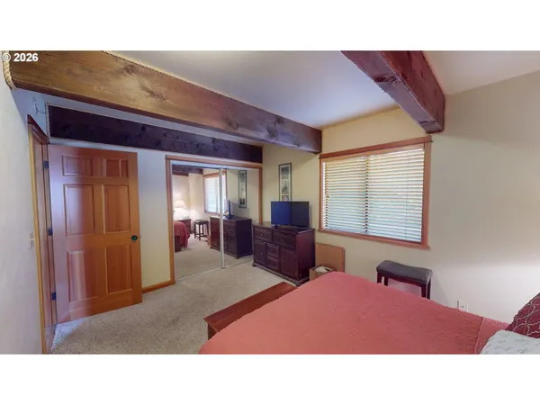 a hallway with a large window and dresser