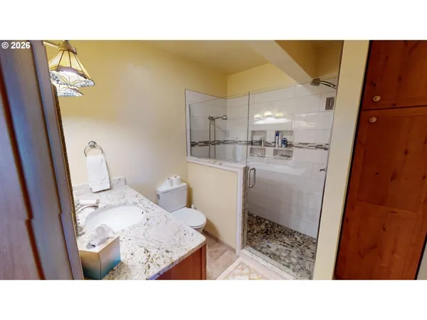 a bathroom with a sink toilet and shower