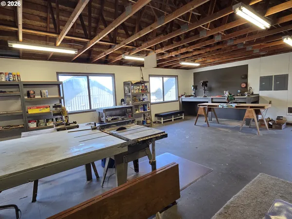 a kitchen with stainless steel appliances sink a stove and white cabinets
