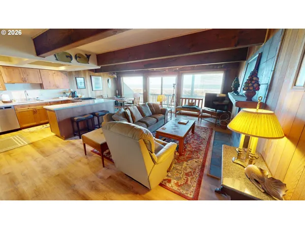 a living room with furniture and floor to ceiling window