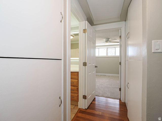 154 East 3000th Street South Bountiful, UT 84010 - Photo 27 of 37 Hallway featuring wood-finish flooring, built-in cabinetry, and neutral wall tones