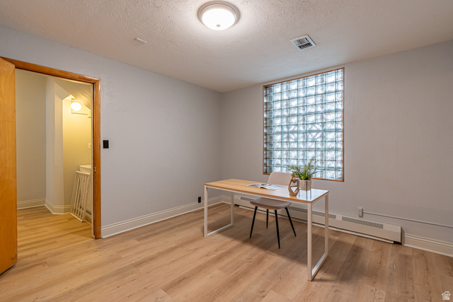 33 North 200 East Logan, UT 84321 - Photo 21 of 54 Office space featuring a textured ceiling, light wood-style flooring, and a baseboard radiator