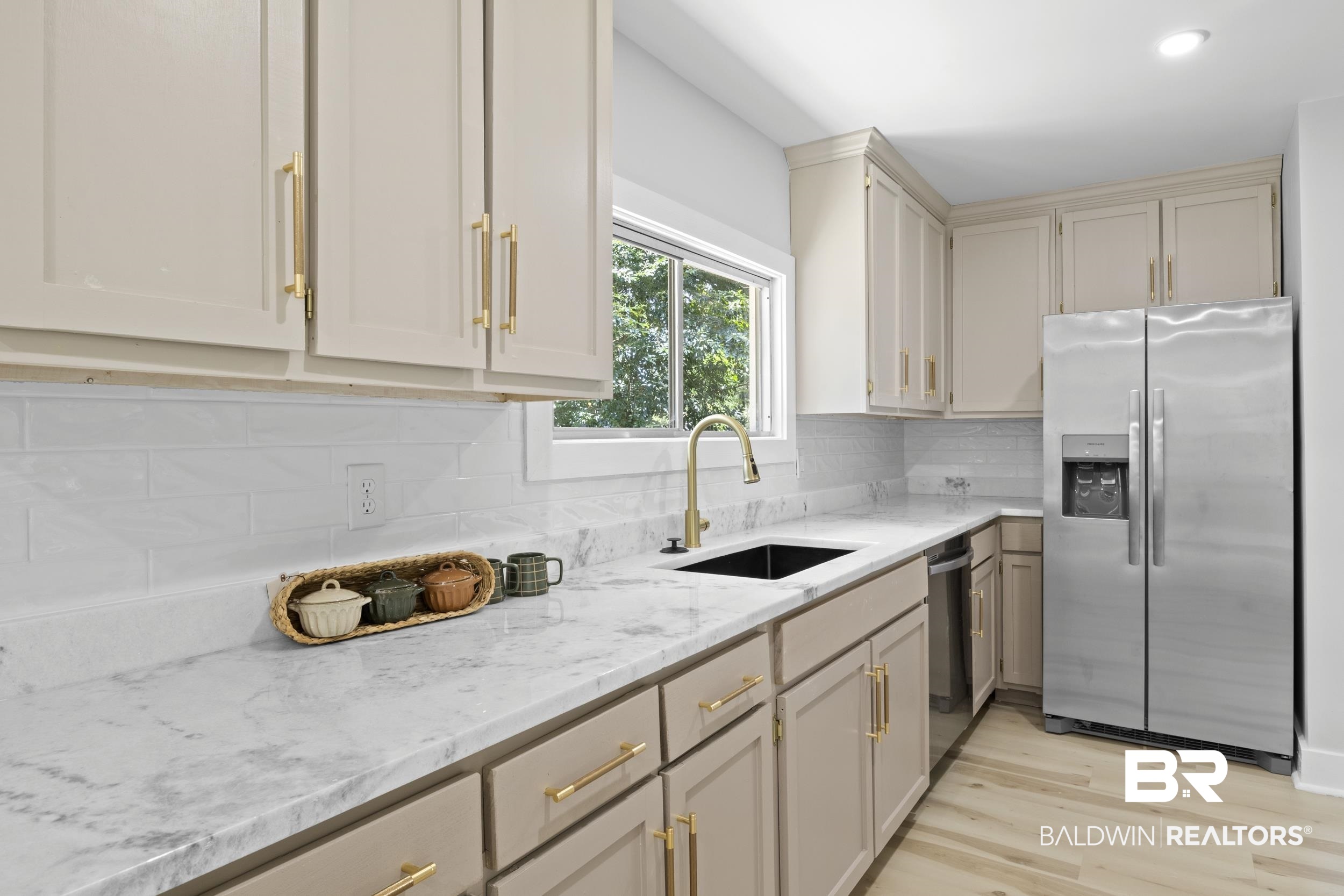 315 Park Avenue Mobile, AL 36607 - Photo 16 of 27 Kitchen with light hardwood / wood-style flooring, light stone counters, appliances with stainless steel finishes, tasteful backsplash, and sink