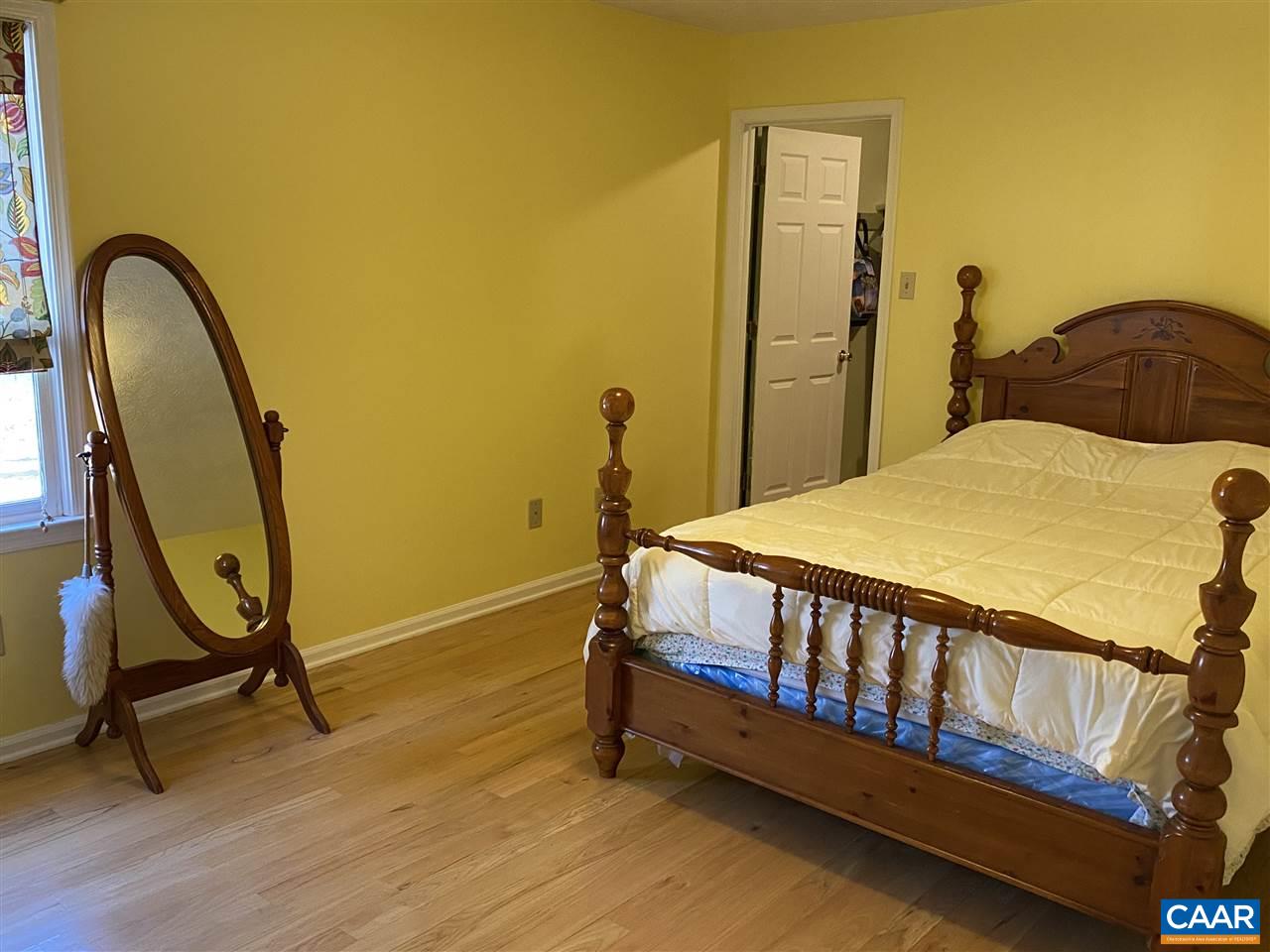72 Tulip Road Ruckersville, VA 22968 - Photo 8 of 15 a bedroom with a bed and wooden floor