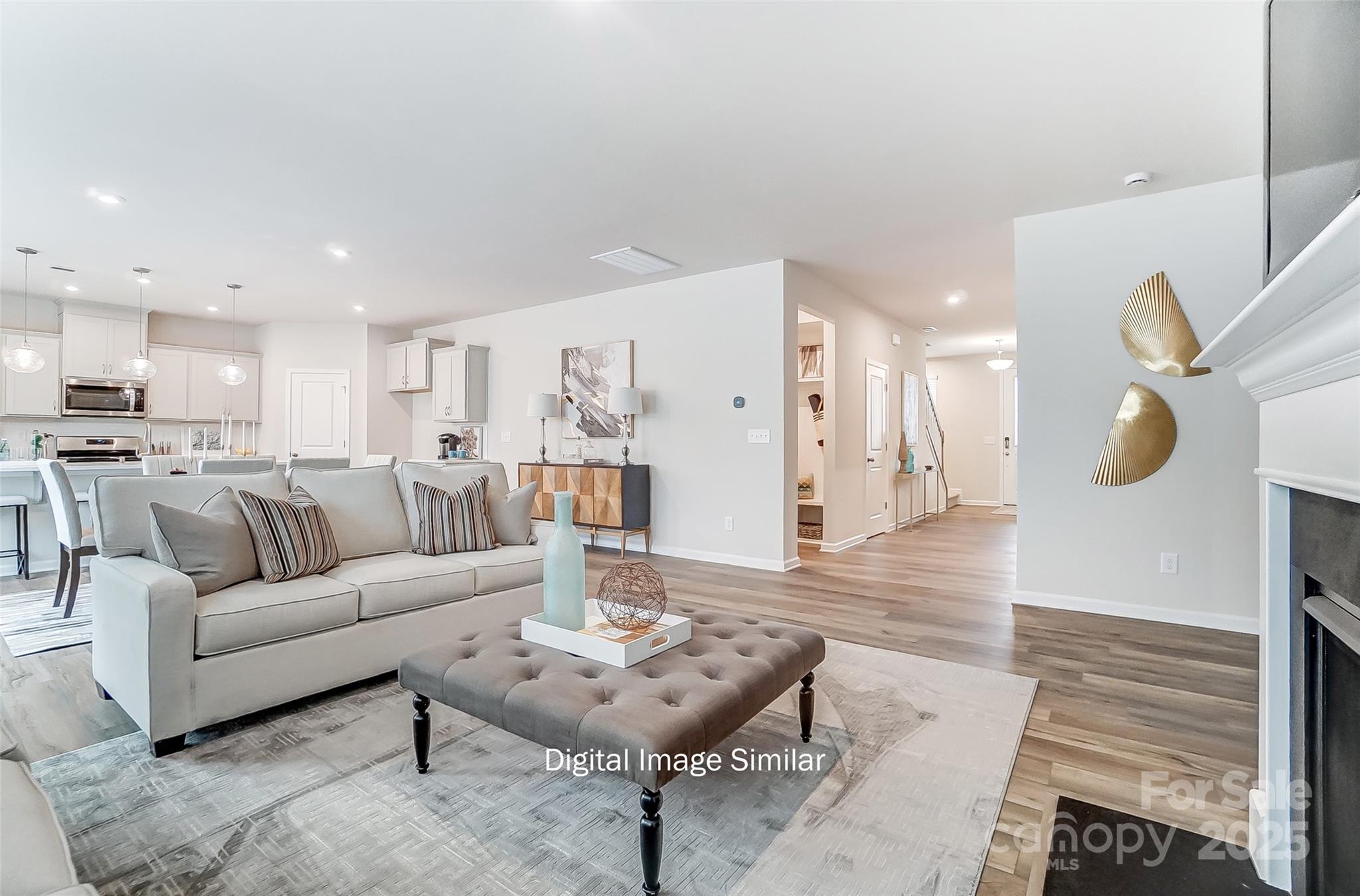 2526 Mabel Lane Monroe, NC 28110 - Photo 21 of 48 a living room with furniture kitchen view and a wooden floor