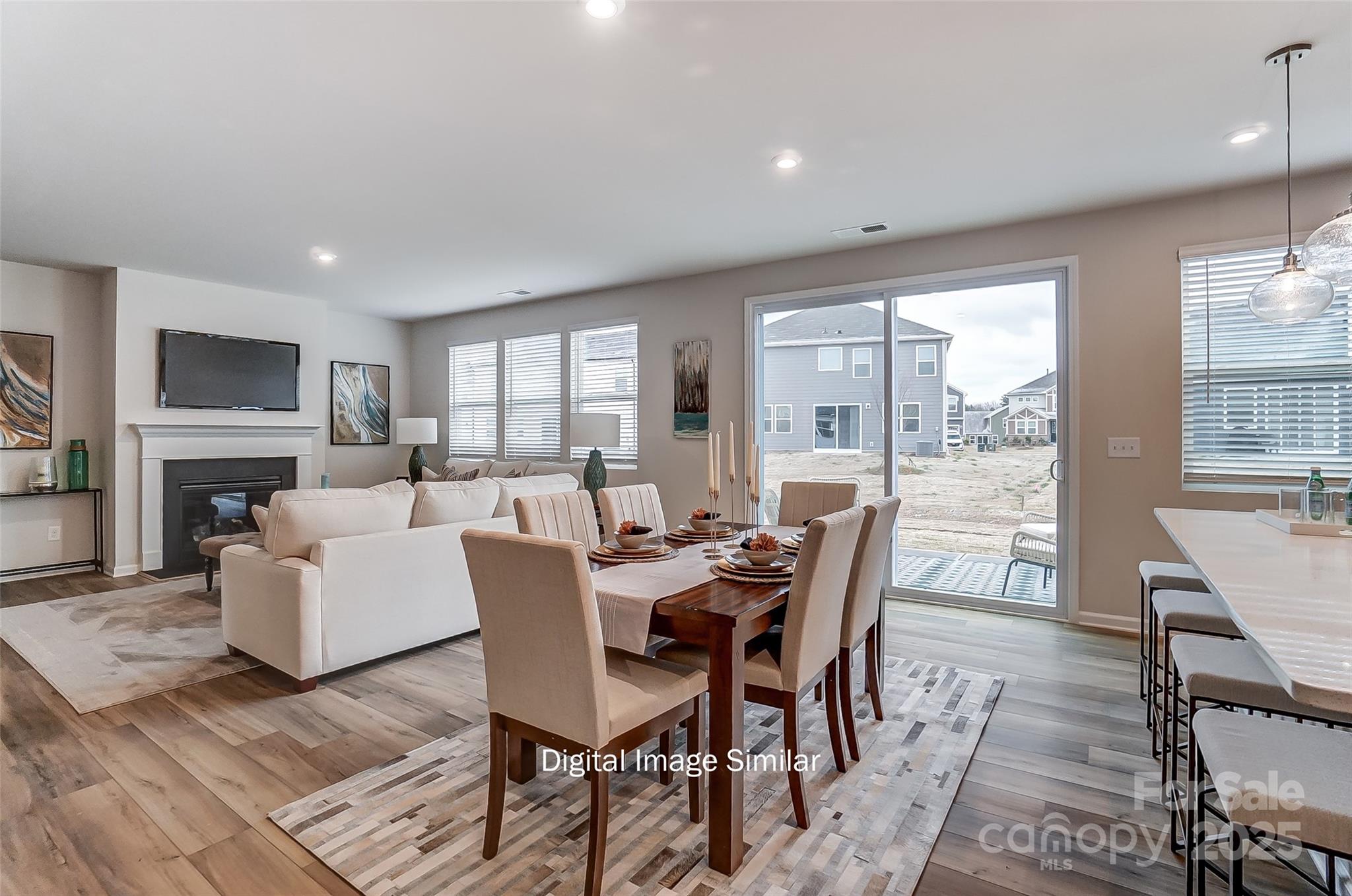 2526 Mabel Lane Monroe, NC 28110 - Photo 25 of 48 a dining room with furniture a fireplace and wooden floor