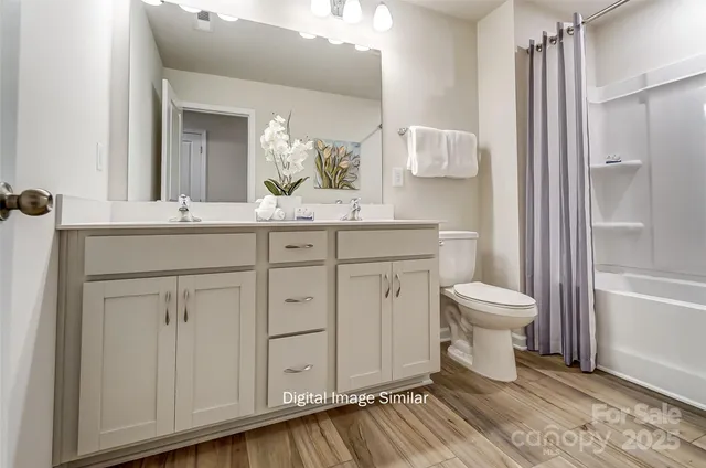 a view of staircase with wooden floor and white walls