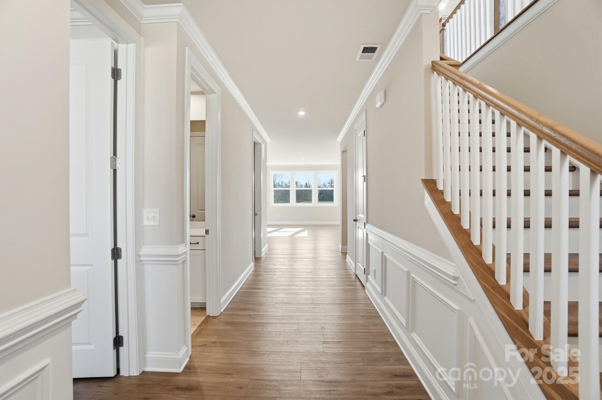2526 Mabel Lane Monroe, NC 28110 - Photo 41 of 48 a view of a hallway with wooden floor and staircase