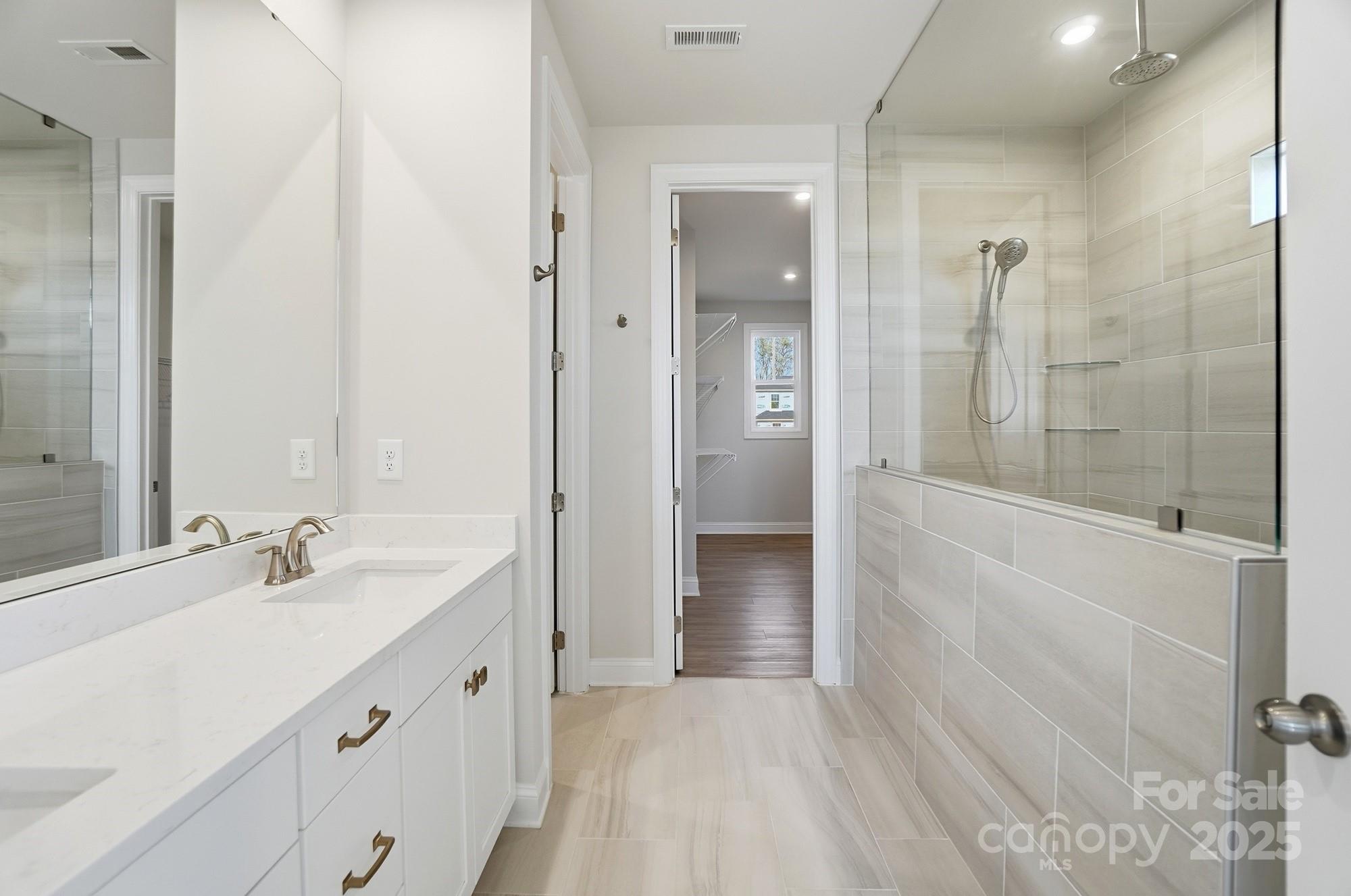 2526 Mabel Lane Monroe, NC 28110 - Photo 48 of 48 a bathroom with a double vanity sink mirror and shower