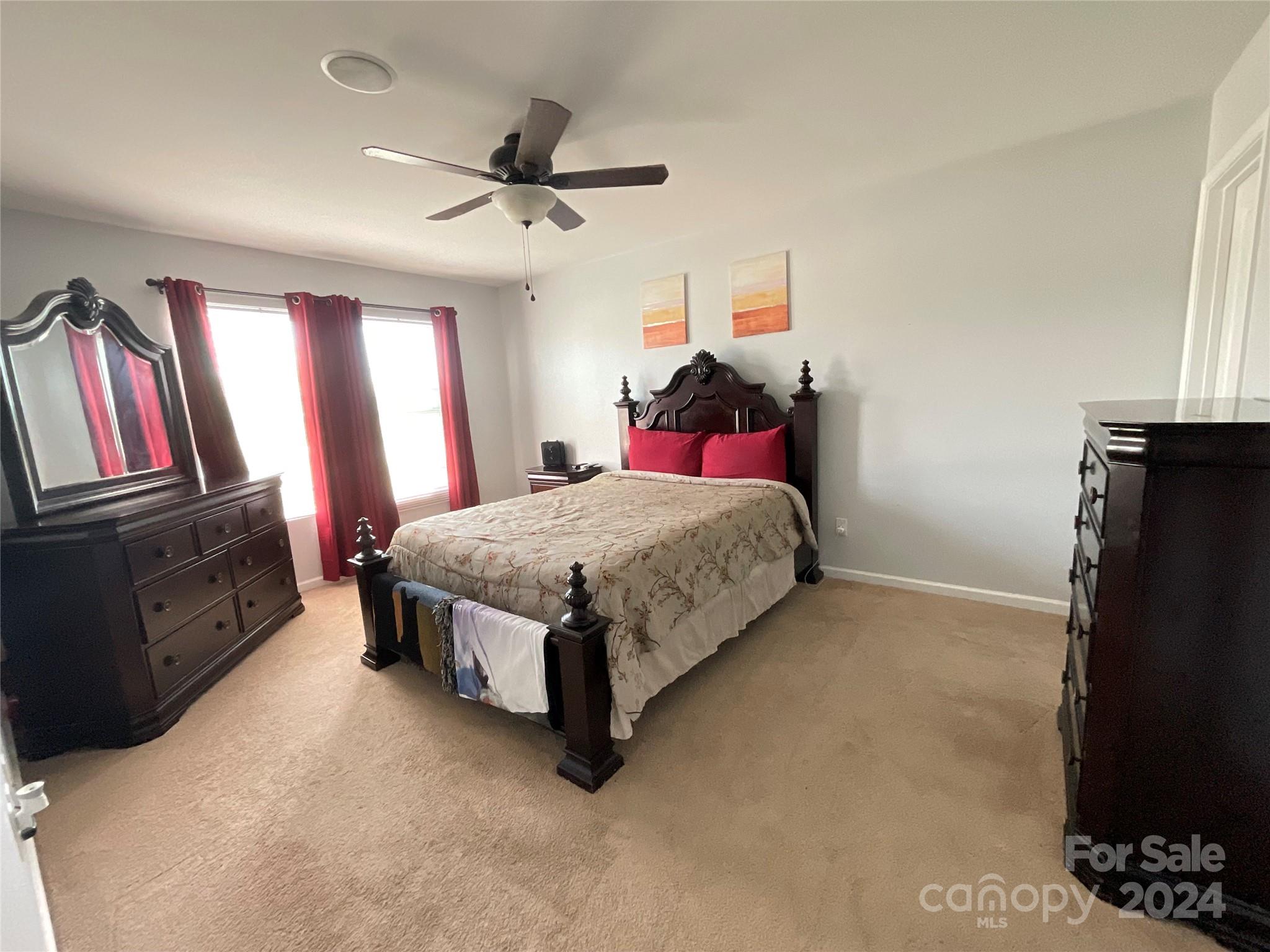 3271 Brickwood Circle Midland, NC 28107 - Photo 12 of 20 a bedroom with a bed flat screen tv and a window