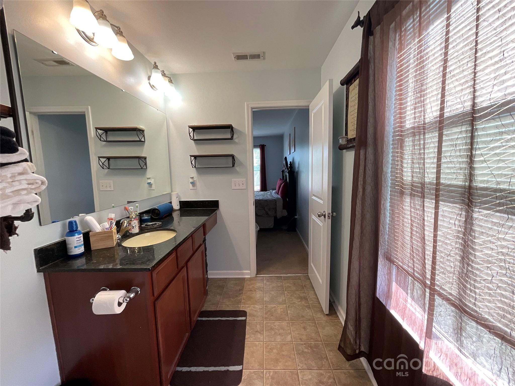 3271 Brickwood Circle Midland, NC 28107 - Photo 14 of 20 a kitchen with kitchen island a sink stove and refrigerator