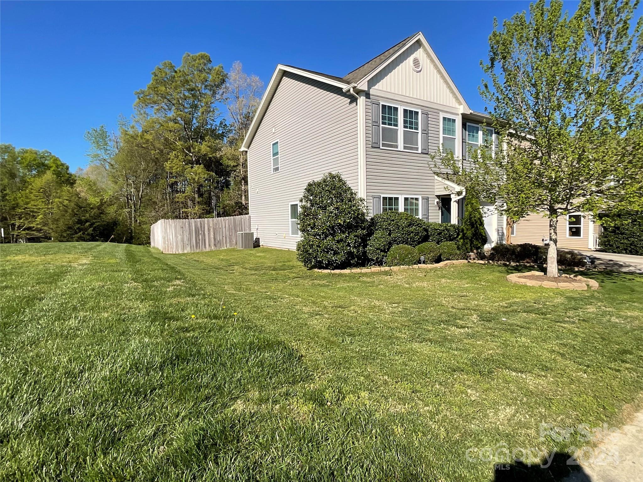 3271 Brickwood Circle Midland, NC 28107 - Photo 3 of 20 a front view of a house with a yard and trees