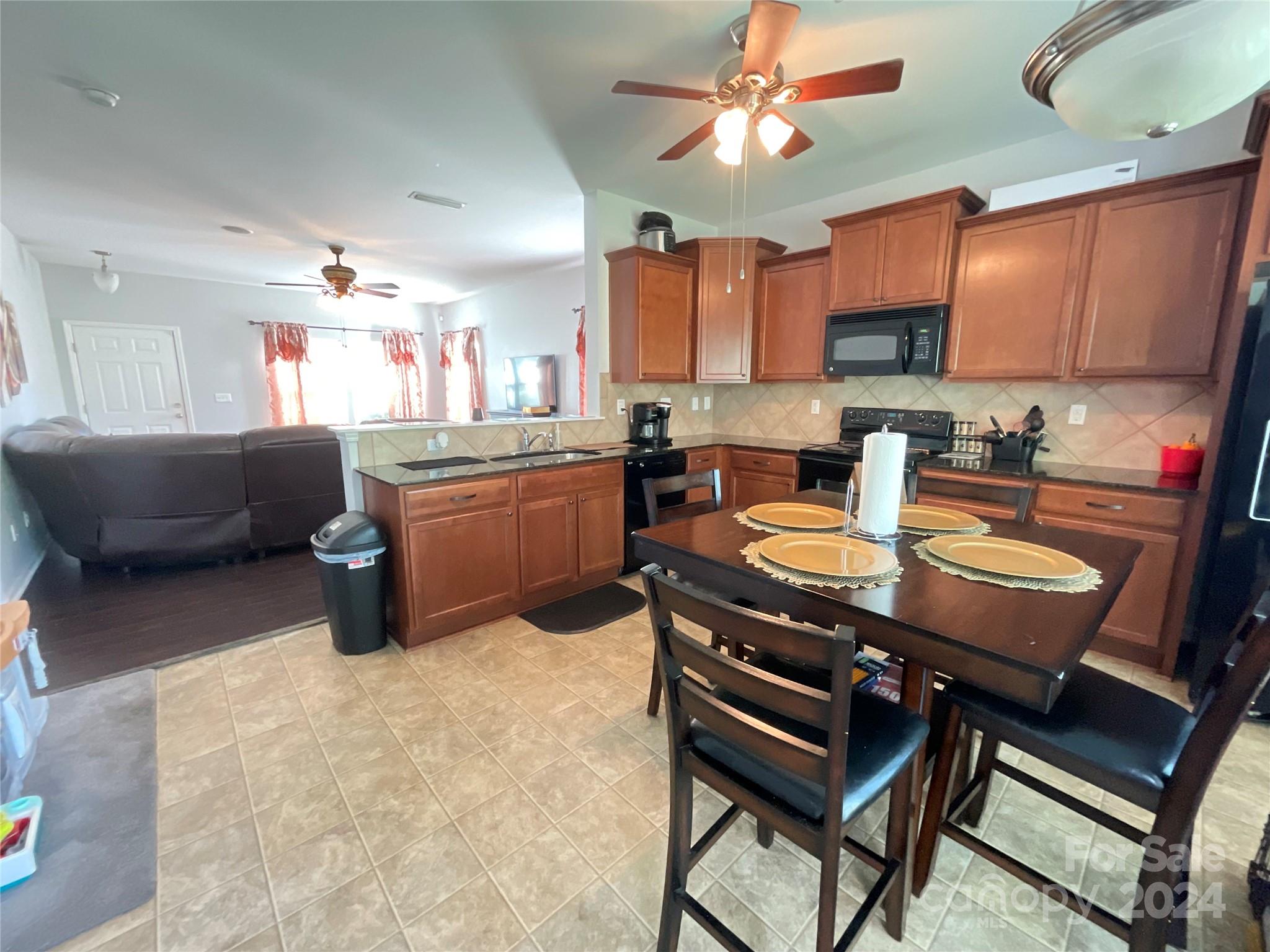 3271 Brickwood Circle Midland, NC 28107 - Photo 7 of 20 a kitchen with a table chairs and a refrigerator