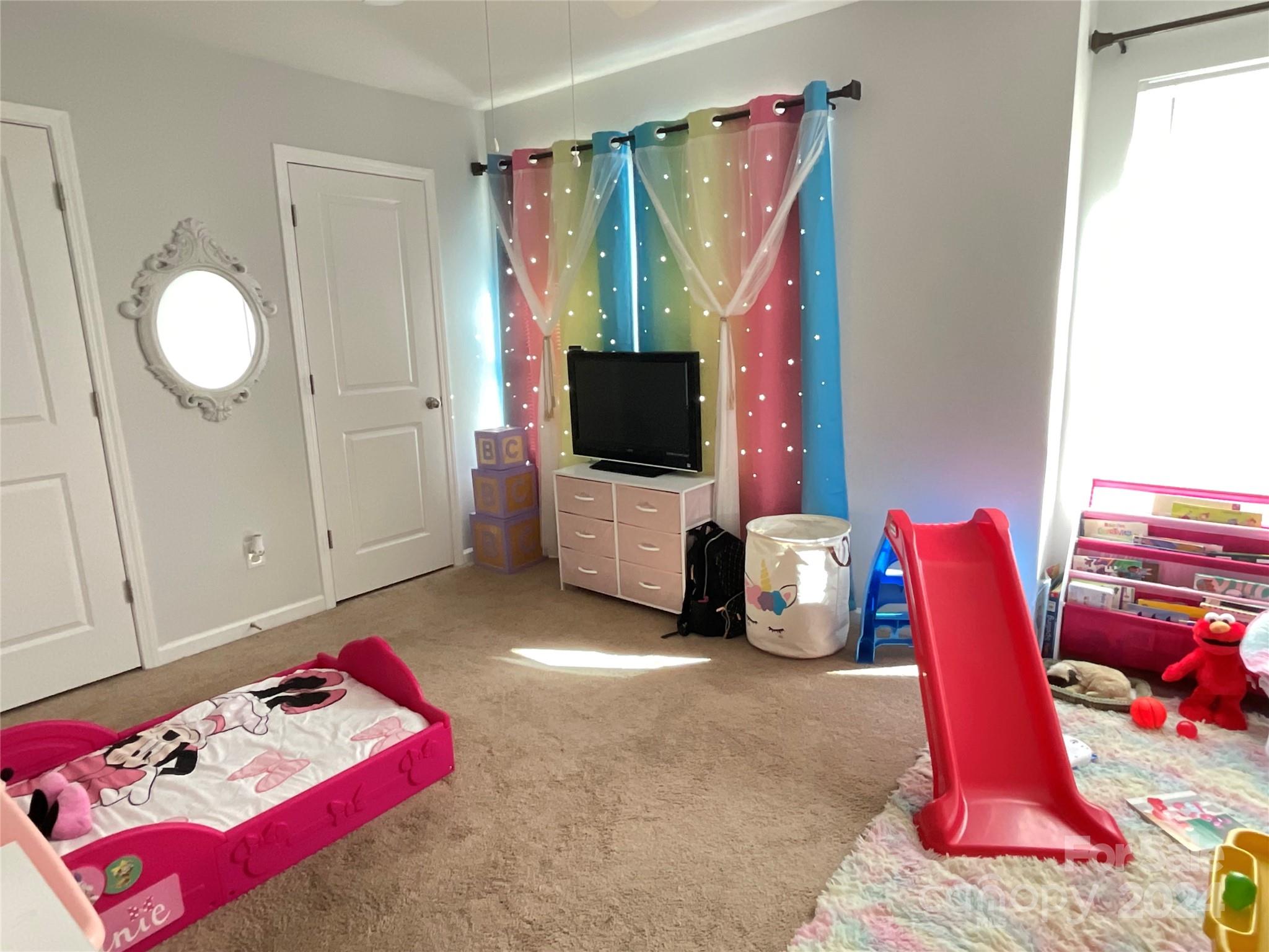 3271 Brickwood Circle Midland, NC 28107 - Photo 10 of 20 a bedroom with a bed and a flat screen tv