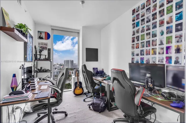 a bedroom with a bed next to a window