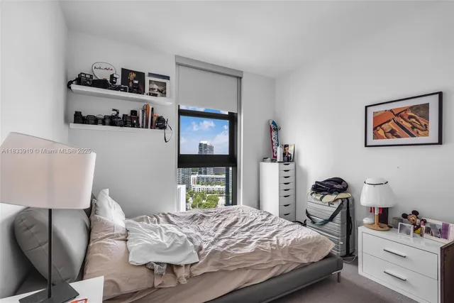 a bed room with a bed and a television