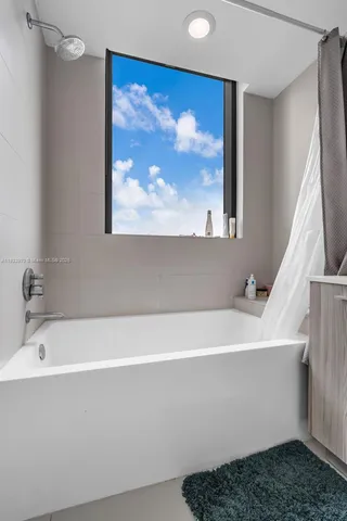 a living room with table tennis pool table and chairs