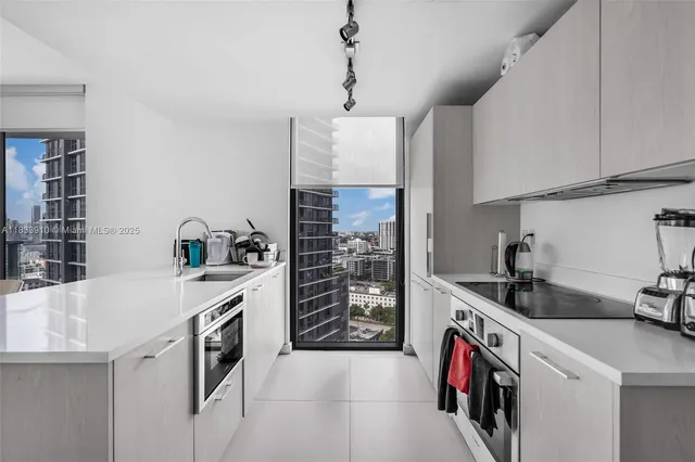 a view of a dining room with furniture a chandelier and wooden floor