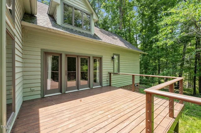 a view of an empty room with a fireplace and a window