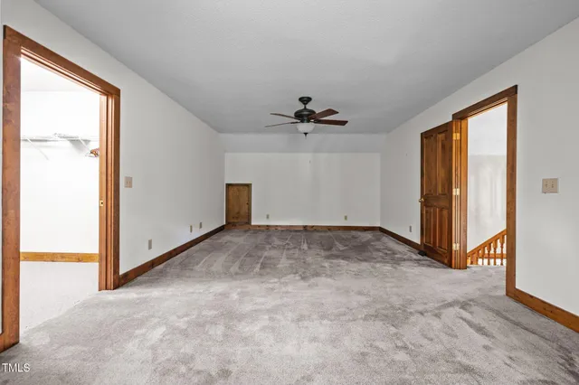 an aerial view of a house with a yard and large trees