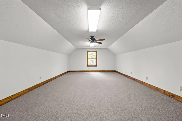 a view of a lush green forest with trees and houses