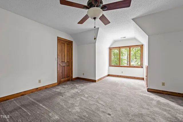 a view of room with wooden floor