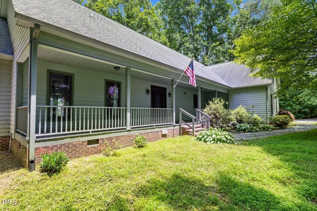 a view of a house with a small yard and flower plants