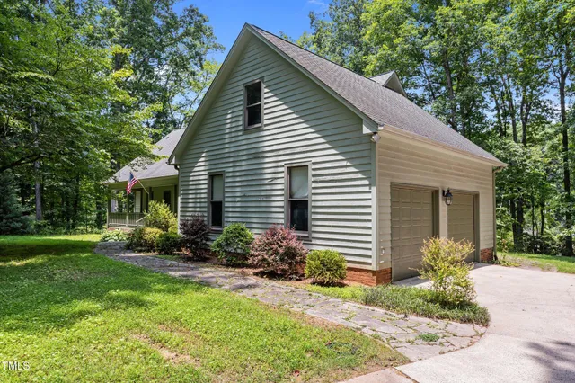 a view of a house with a yard and plants