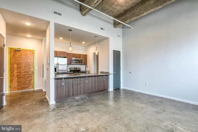 a open kitchen with kitchen island a sink stainless steel appliances and cabinets