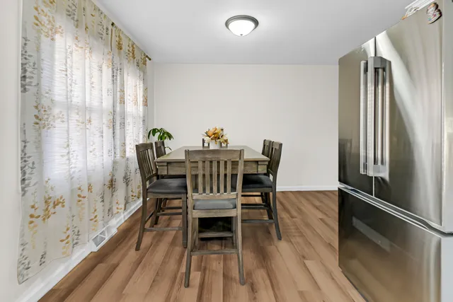 a dining room with furniture and wooden floor