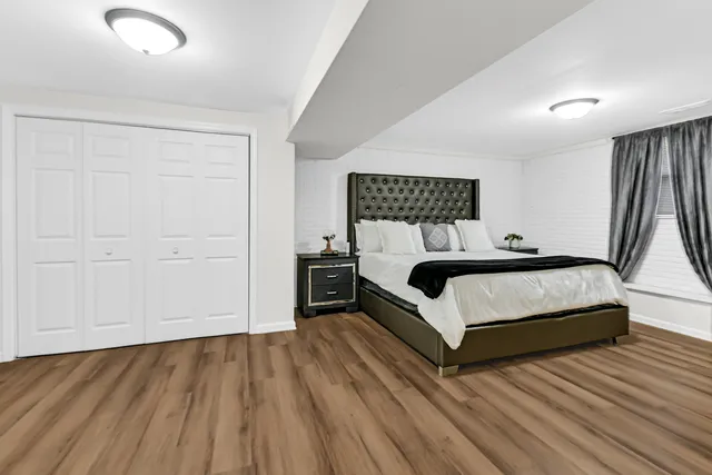 a bedroom with a bed and a night stand