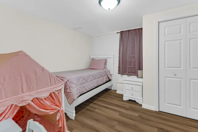 a spacious bedroom with a bed and a cabinets