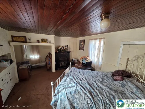 a view of a hallway with furniture and a window