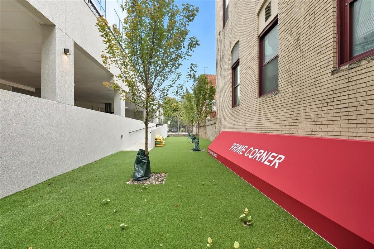 303 Madison Street, Unit 406 Hoboken, NJ 07030 - Photo 24 of 29 a view of a street with a building and trees